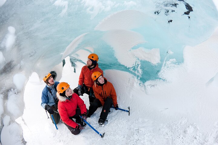 Group hiking on Sólheimajökull glacier, crampons on blue ice with crevasses